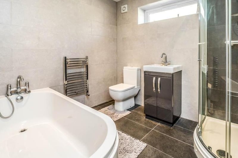 The large bathroom is fitted in a contemporary style, with separate bath and shower and plenty of light.