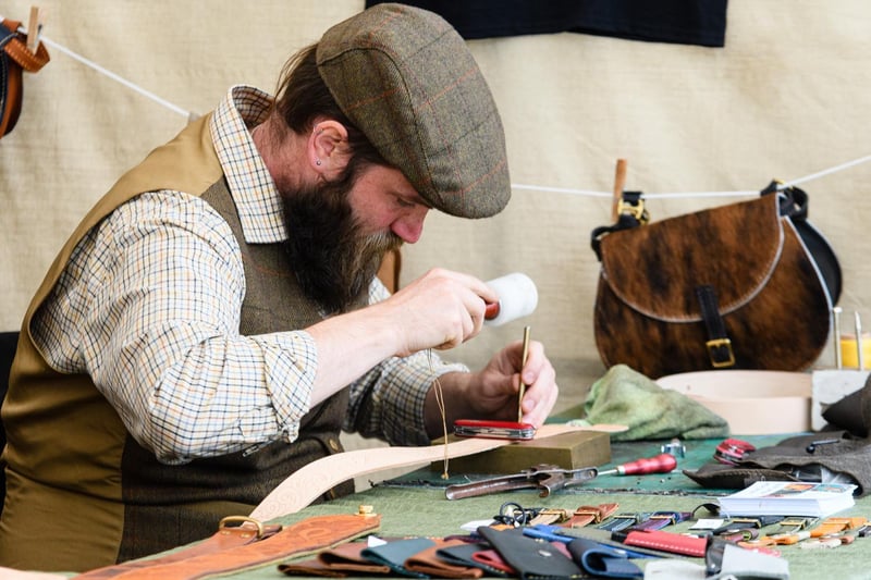 Ben Hollings of The Anvil Workshop tooling some leather at the Royal Lancashire Agricultural Show 2021.
