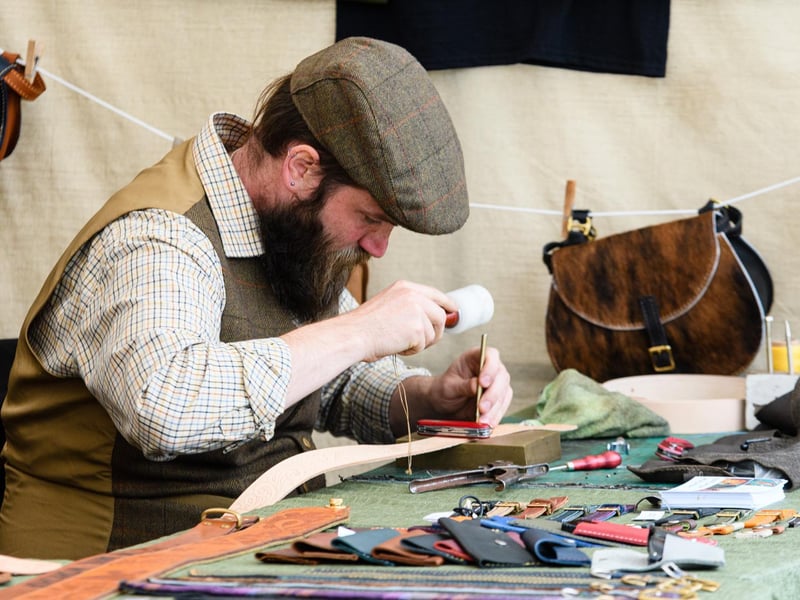 Ben Hollings of The Anvil Workshop tooling some leather at the Royal Lancashire Agricultural Show 2021.