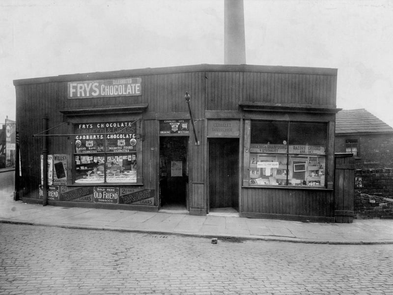 Retail premises on Botany Bay Place at the junction of Canal Road in Armley in April 1923. On the right is Charles Coakley, hairdresser, and on the left is Moran Valentine confectioners.