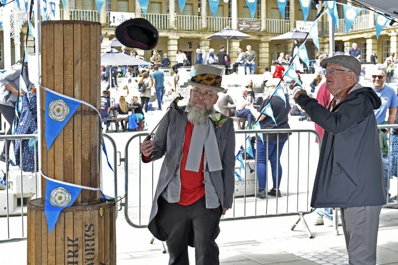 Yorkshire Hat Throwing Championship at The Piece Hall. Tony West of Cleckheaton throws the hat watched by Glyn Watkins, founder of the Yorkshire Hat Throwing Championship
