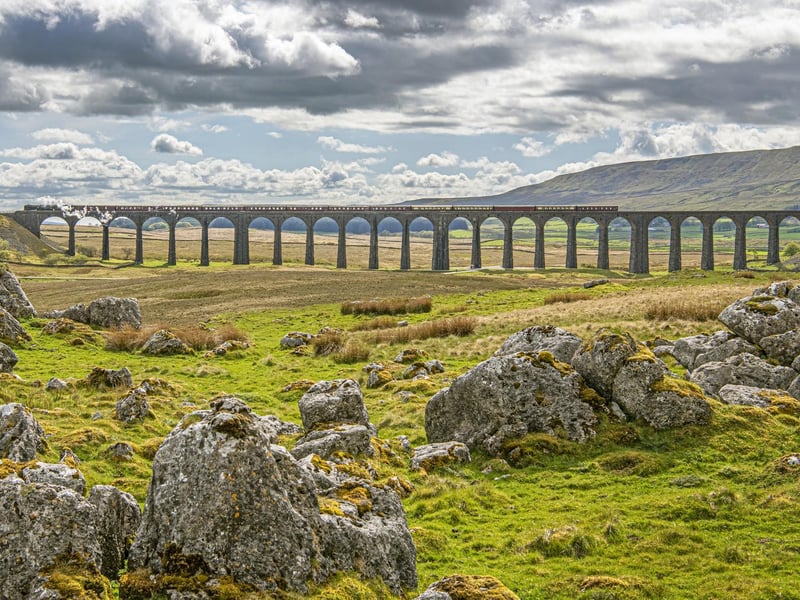 The Ribblehead Viaduct is a stunning landmark situated in the North Yorkshire countryside, right on the Cumbrian border. This breathtaking 4-mile hike initially follows the Settle-Carlisle railway line, before heading up toward the small, cobbled village of Dent.