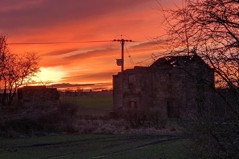 This photo illustrates the mesmerising colours of the sun setting on the countryside.