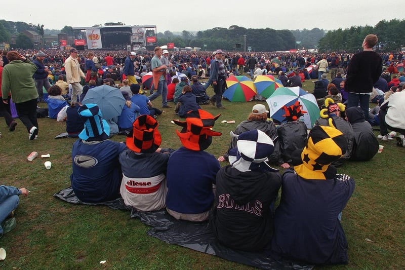 The crowds sit and watch the music at V98 held at Temple Newsam Park.