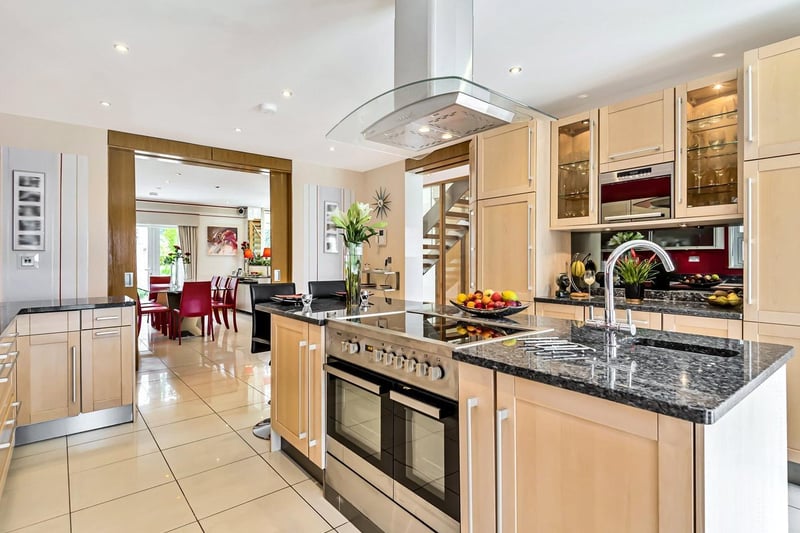 The dining room leads through an archway into the stunning modern, kitchen.  This room benefits from integrated appliances such as the Miele fridge and Teknix ovens. The light filled room also has a breakfast bar perfect for casual family dining.