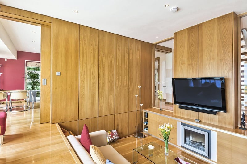 One of the most striking features is the family room, with bespoke sunken seating area with acoustic wooden wall panels and spectacular views over the rear beautiful garden and beyond. This is a wonderful, cosy space.