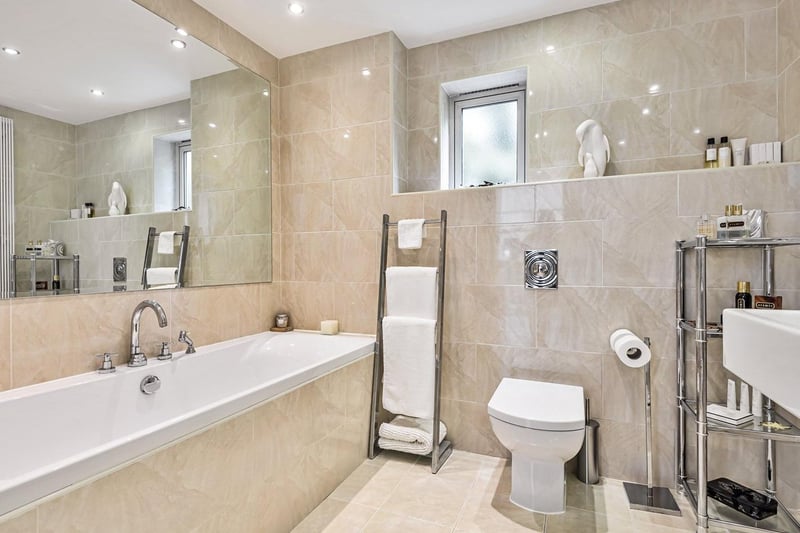 The family bathroom is a modern space, with large bath and twin sinks.
