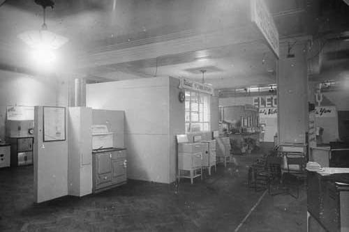 In view are a number of cookers at the 1944 exhibtion. To the left is a solid fuel cooker, this model is called a 'Yorkdale'. In the centre are several small electric models with solid rings, grill, oven and pan rack underneath.