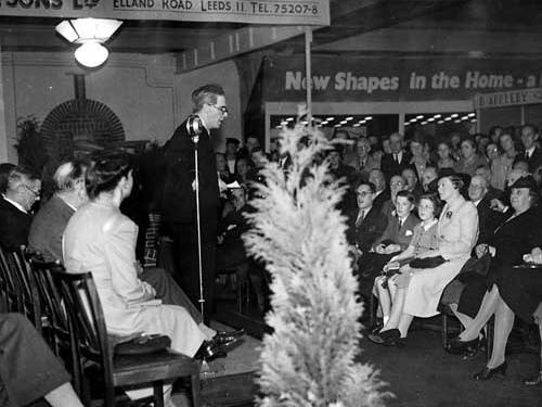 Professor A.M. Low makes the opening speech at the exhibition in 1945. A fashionably dressed woman, two children are on her left. The boy is formally dressed complete with a handkerchief in the pocket of his jacket.