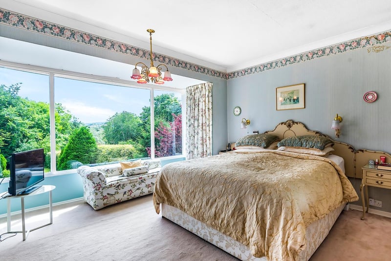 An elegant bedroom with a large picture window