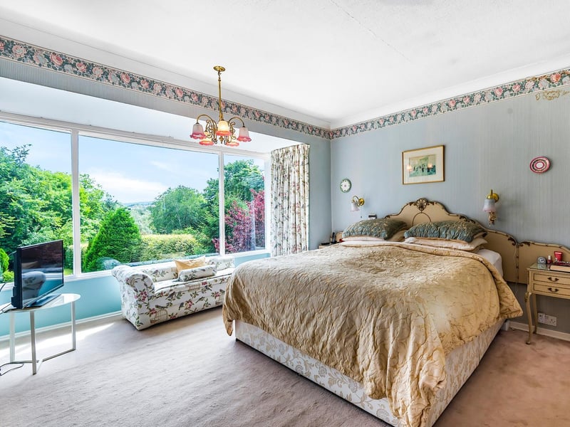An elegant bedroom with a large picture window