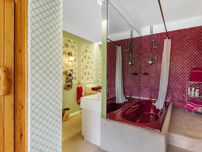 Steps up create a sunken bath in this colourful bathroom