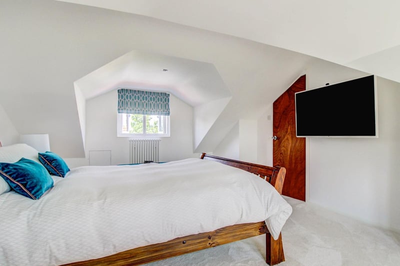One of the four bedrooms is located on the top floor and has a flat screen TV.