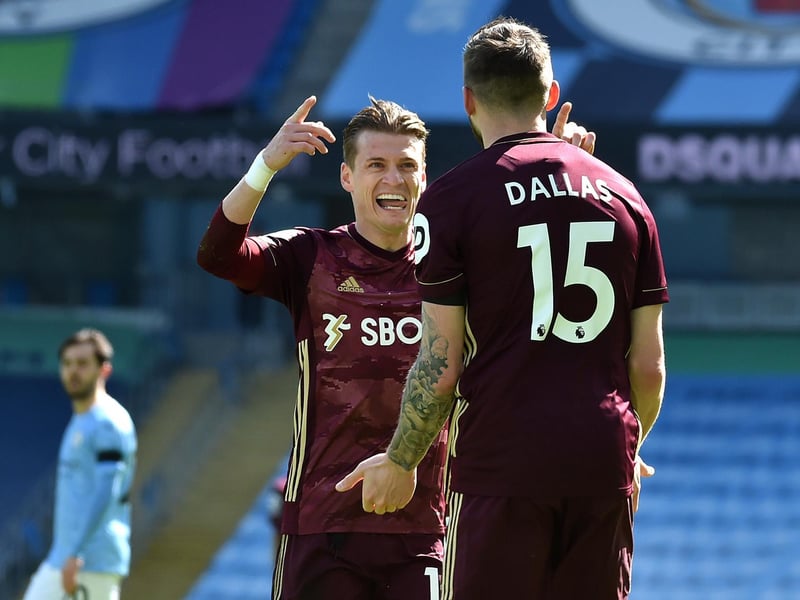 Ezgjan Alioski congratulates Stuart Dallas after he scored against Manchester City at Etihad Stadium in April 2021.