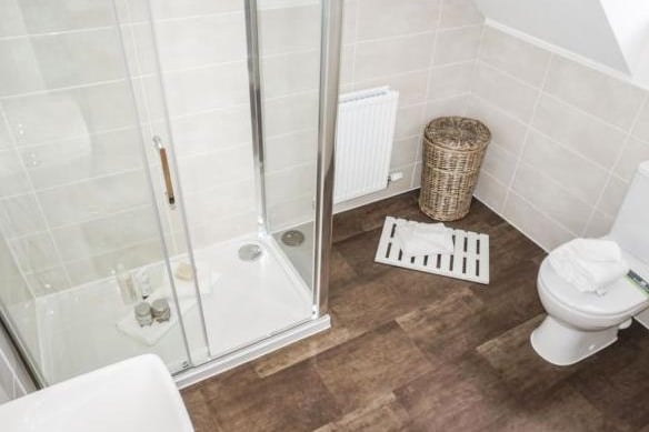 Luxury suite comprising of a walk in shower cubicle, low level WC, pedestal wash hand basin, part tiled walls, low voltage inset spotlights, frosted double glazed window, radiator.