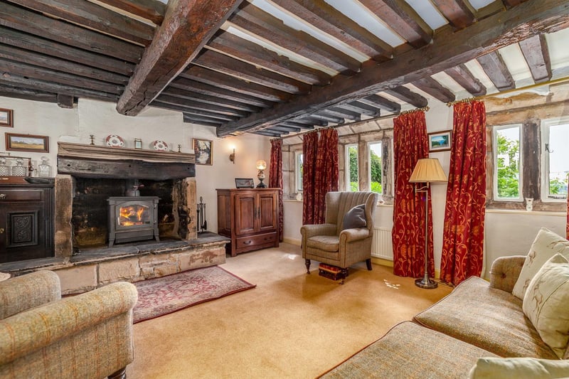 A lower ceiling and the log burner in the fireplace make this room snug and inviting