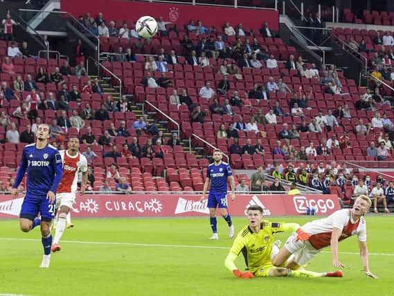 GOAL-BOUND: Leeds United goalkeeper Illan Meslier, right, Pascal Struijk, left, and Stuart Dallas, behind, can only look on as Perr Schuurs puts Ajax 2-0 up. Photo by GERRIT VAN KEULEN/ANP/AFP via Getty Images.