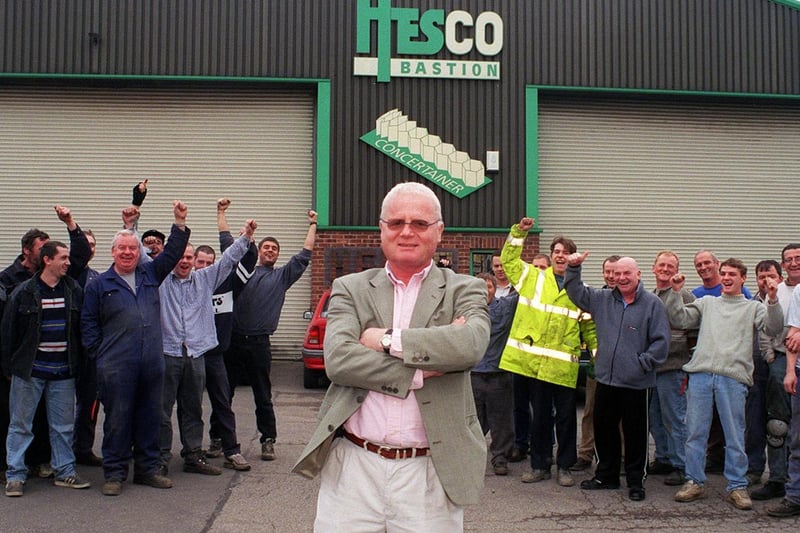 Staff at Hesco Bastion celebrate after owner Jimmy Heselden (centre) announced he was paying for them to go on holiday to Benidorm.