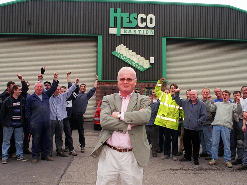 Staff at Hesco Bastion celebrate after owner Jimmy Heselden, centre, announced he was paying for them to go on holiday to Benidorm.