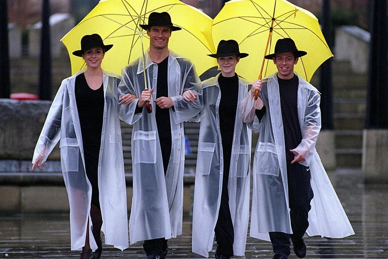Members of the cast from the West Yorkshire Playhouse production of 'Singin' in the Rain'" get some rehearsal time in the real stuff. Pictured are Rebecca Thornhill, Paul Robinson, Zoe Hart and Mark Channon.