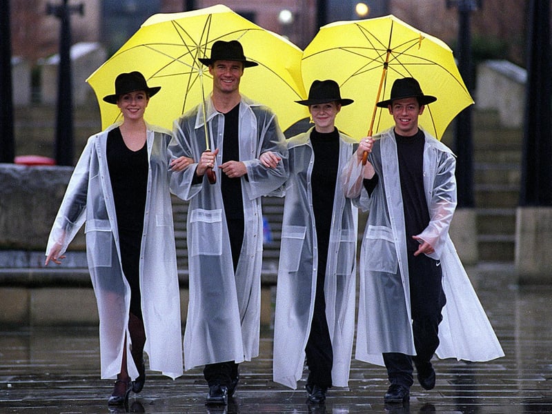 Members of the cast from the West Yorkshire Playhouse production of 'Singin' in the Rain'" get some rehearsal time in the real stuff. Pictured are Rebecca Thornhill, Paul Robinson, Zoe Hart and Mark Channon.