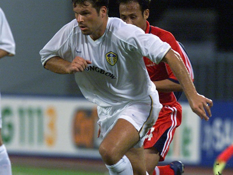 Striker Mark Viduka is pursued by W. Nubthong.