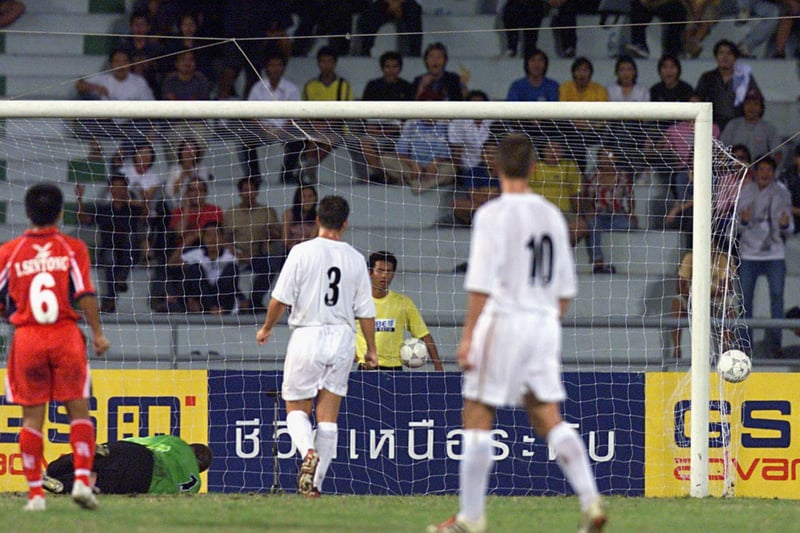 Kiatisuk Senamuang ( not in picture ) scores for the Bangkok XI just before half-time.
