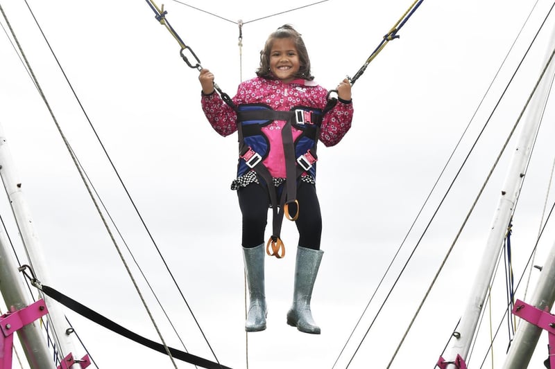 Seven-year-old Aria Haxby enjoying the bungee trampoline ride.