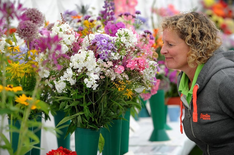 The annual Garstang Agricultural Show, Garstang. Helen Smith smells the flowers in the horticulture marquee. Picture by Paul Heyes, Saturday July 07, 2021.