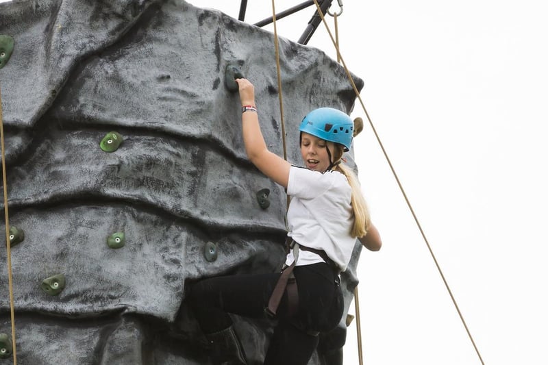 Demi Holmes, 12, gives the Brodstock climbing wall a try.
