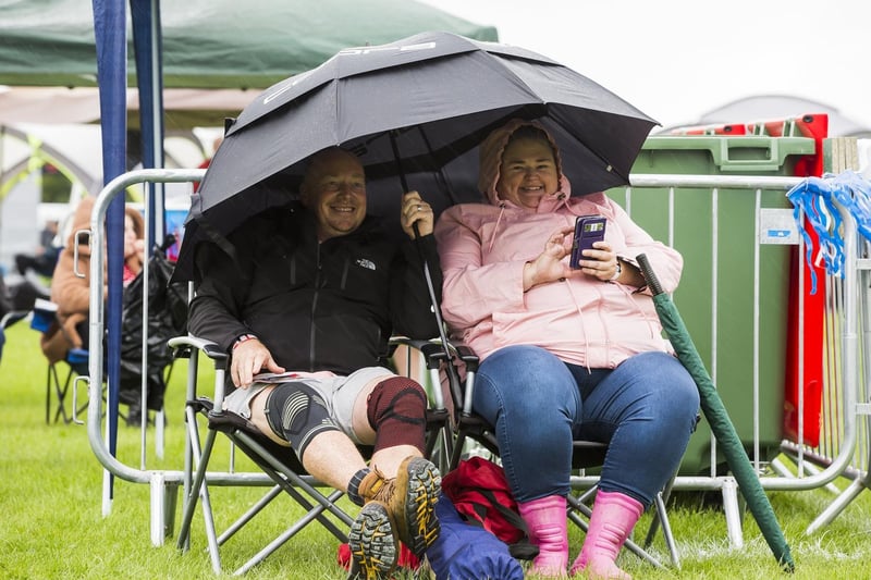 Sheltering from the Brodstock rain are Mark and Lorraine Mitchell.