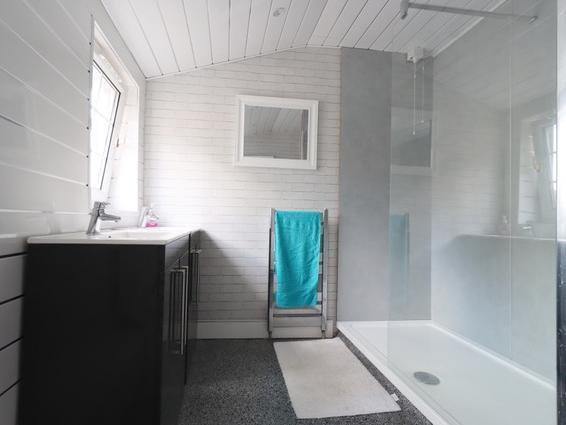 A large walk-in shower features in this facility