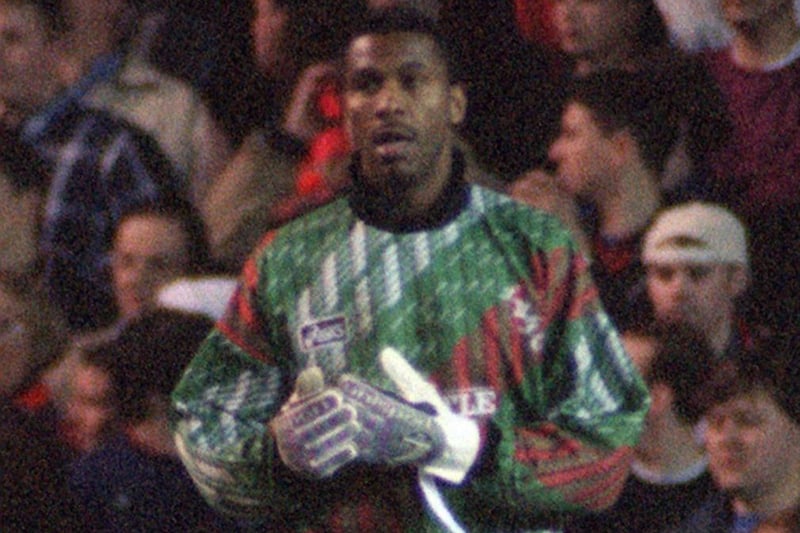 Radebe putting on the gloves for his 70 minute stint in goal against Manchester United.