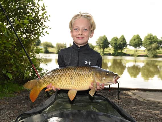Alex Hilditch, ten, with one of the fish he caught.