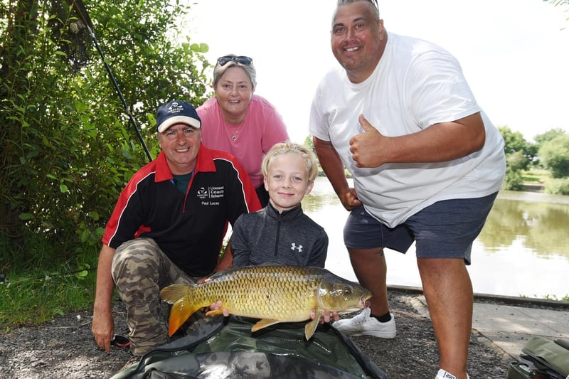 Alex Hilditch, ten, with one of the fish he caught, pictured with, from left, Paul Lucas and Jackie Burns from Moathouse Fisheries and event organiser Zacc Harvey.