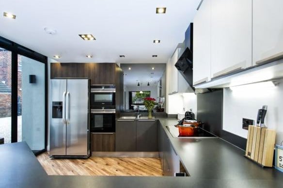 The kitchen is similarly filled with light due to the double glazed side facing window.