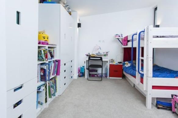 The third bedroom is a spacious room. The current owners have utilised the space with fitted wardrobes and a bunk bed.