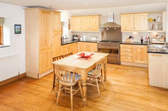 The country-style kitchen is also on this floor and is a good size with integrated appliances and room for a family dining table.