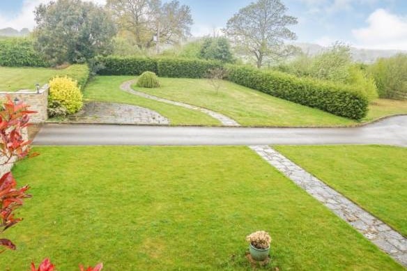 The property occupies an impressive plot and enjoys extremely well maintained lawned gardens to the front.