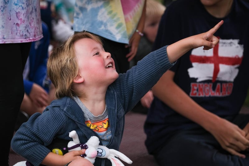 One youngster enjoys the Punch and Judy show.