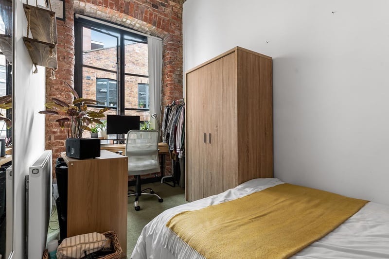 The second bedroom is slightly smaller but also easily fits a double bed. It has laminate flooring but also enjoys exposed brick wall, high ceilings, feature wooden beams and a sliding door to living area. This could be kept as a bedroom or turned into a handy home office space.