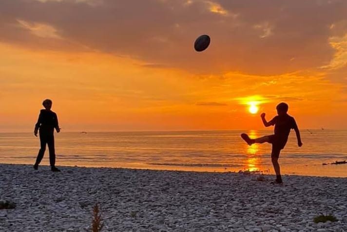 Trisha Gaskell - watching the sunset on holiday, while the boys practice rugby.