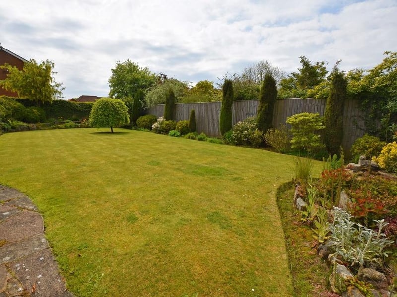A closer view of the attractive rear garden with the property