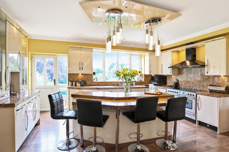 A central island provides room for seating in the modern kitchen
