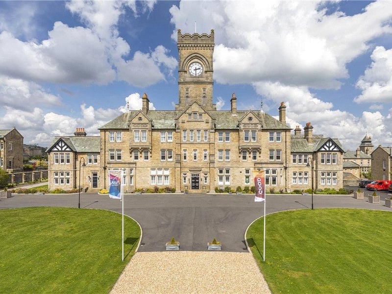This exquisite penthouse apartment in Menston is set within the grandeur of a Victorian Clock Tower which formed part of the original hospital buildings. The homes within this historic building have been painstakingly transformed during the restoration process but still maintain many unique and original features such as the tall windows and high corniced ceilings. The apartment itself is set over two floors and has been modernised by the current owner to include handmade handmade with bespoke island units, Siemens appliances, and a living living feature TV wall with bespoke Dekton wall hanging unit with integrated Sky box, Sonos sound bar and TV. The property is set within grounds of approximately 200 acres of park and woodland. It is on the market with Dacre, Son & Hartley for £499,950.
