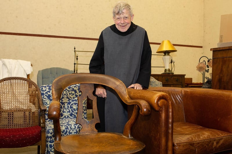 Fr John with some of the furniture up for sale at the auction