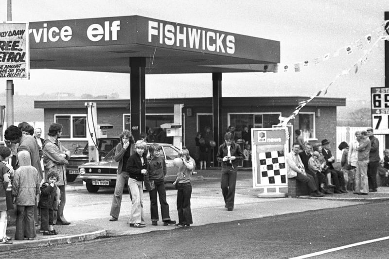 A vintage car rally passes through Fishwick's service station in Up Holland Road Billinge in 1978