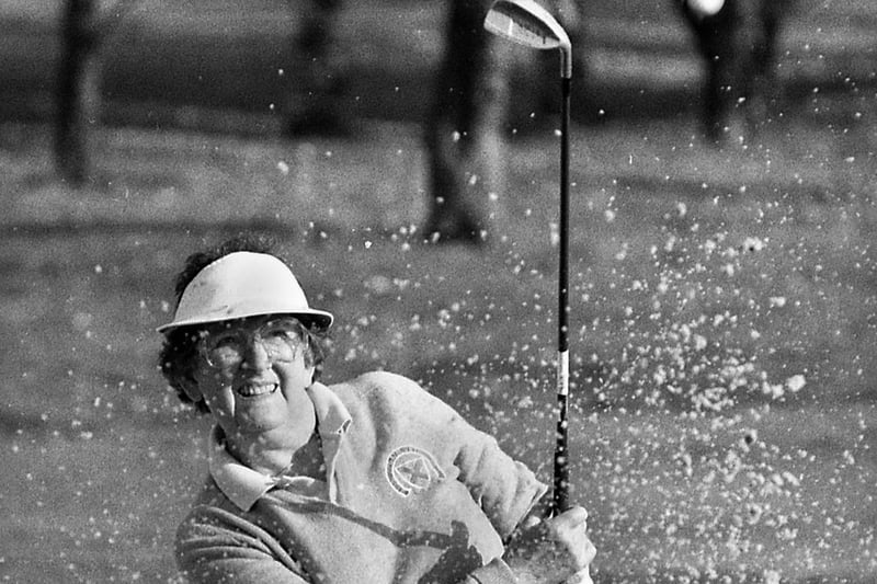 Gathurst Golf Club member, Rhona Perkins, splashes out of a bunker during a charity golf day in aid of Wigan Hospice at Arley on Friday 14th of October 1994.
