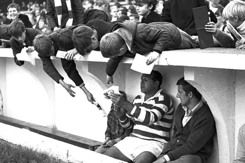 Billy Boston signs autographs in the dug out