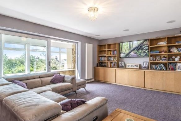 The lounge is another spacious room in which the owners have a large L-shaped sofa, and a media unit with mounted tv, for all the family to enjoy on an evening. It boasts incredible views across the gardens.
